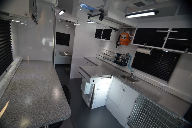 Modern mobile kitchen interior featuring a clean, functional design with a countertop, sink, and storage areas. Ideal for food preparation on the go.